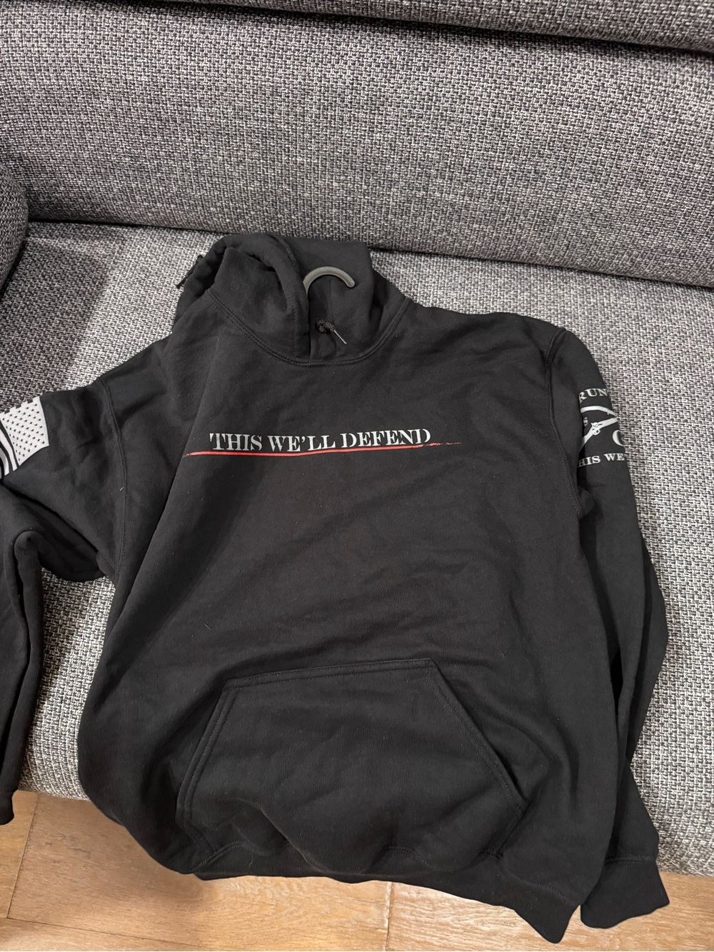 Grunt Style Black Hoodie with "This We'll Defend" Graphic